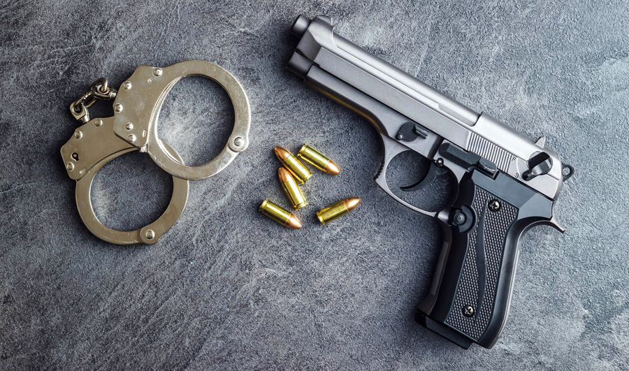 Pistol bullets, handgun and handcuffs.